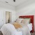 a bedroom with a bed and a fan