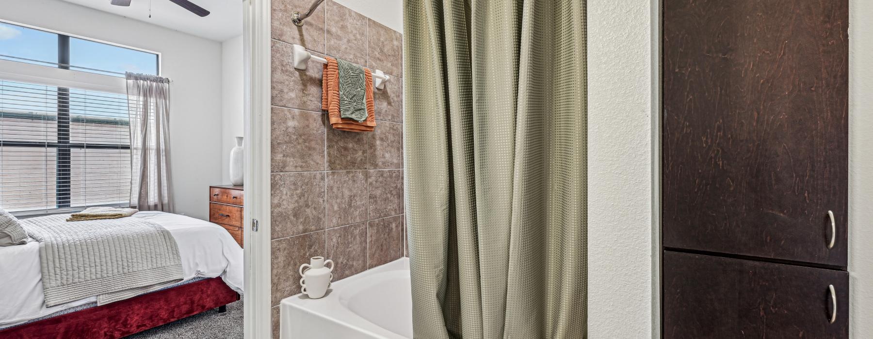 a bathroom with a bed and a bathtub