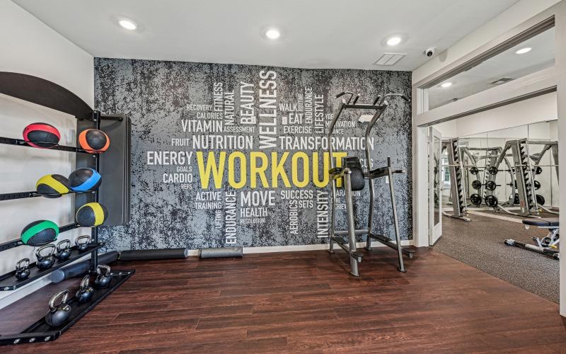 a room with exercise equipment and a sign on the wall