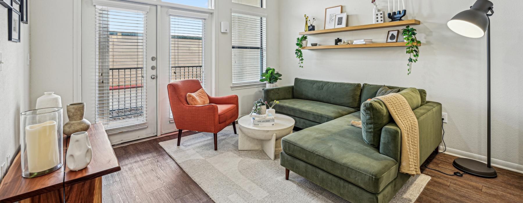 a living room with a green couch and a table