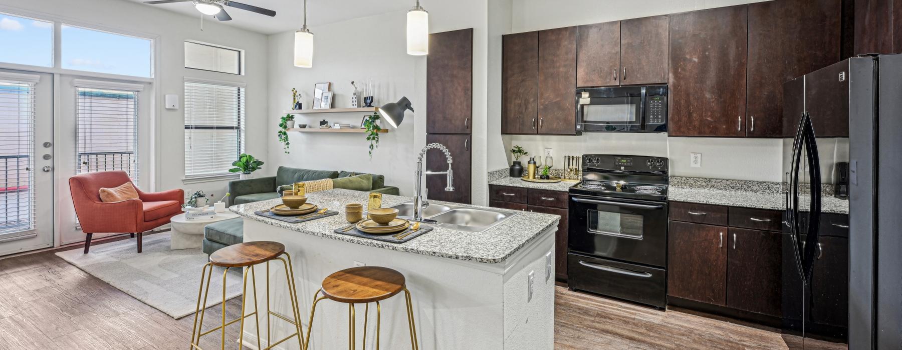 a kitchen with a table, chairs and wood cabinets