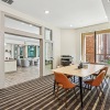 a private clubhouse room with a large glass door and a tv