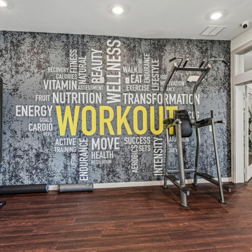 a room with exercise equipment and a sign on the wall